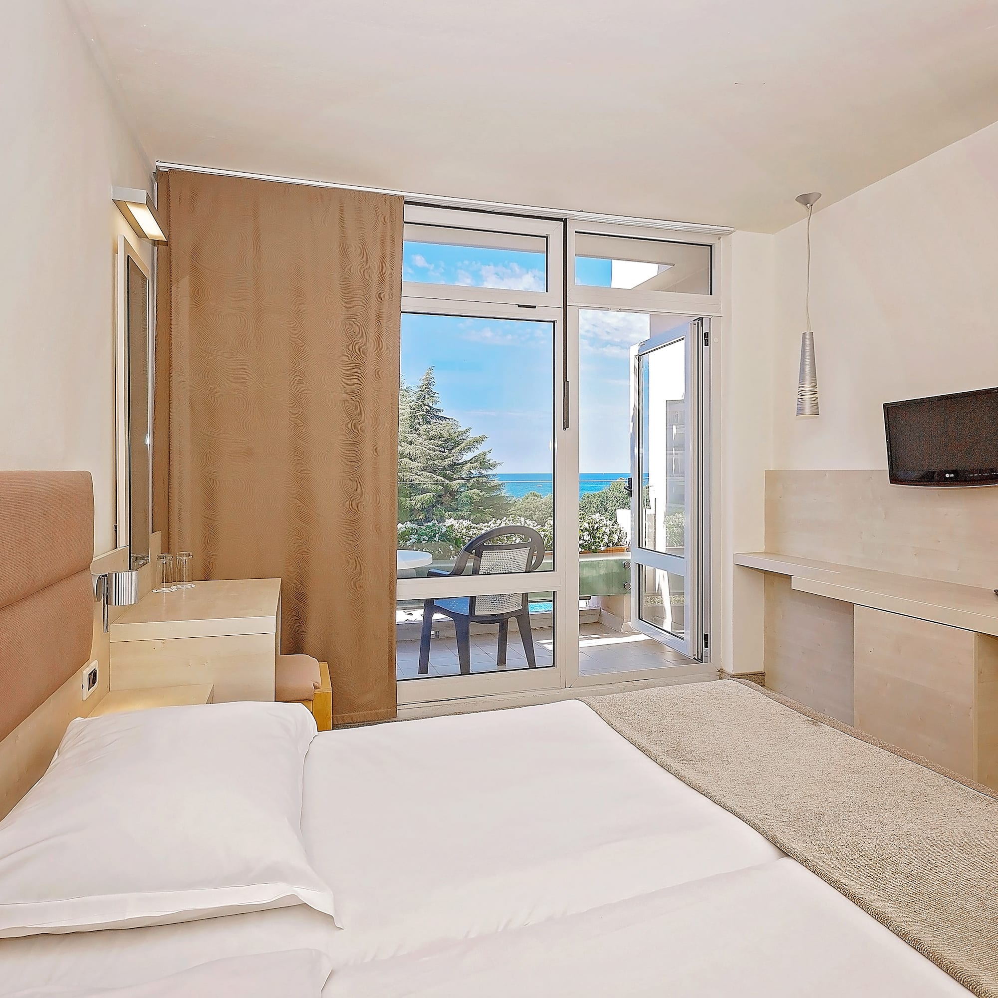 a bedroom with a large bed and a glass door