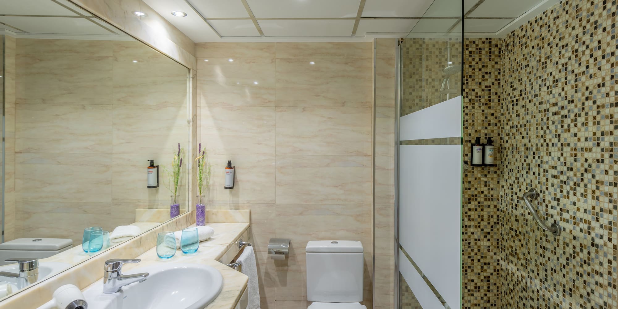 a bathroom with a shower and sink