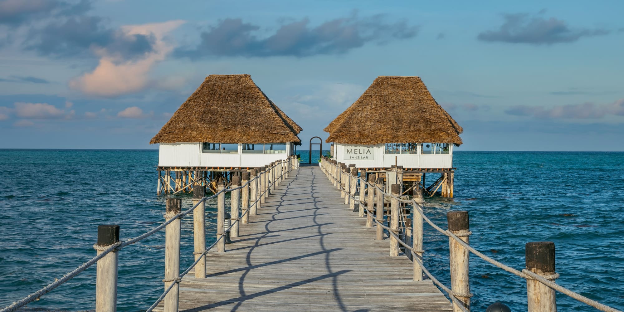a dock leading to two huts