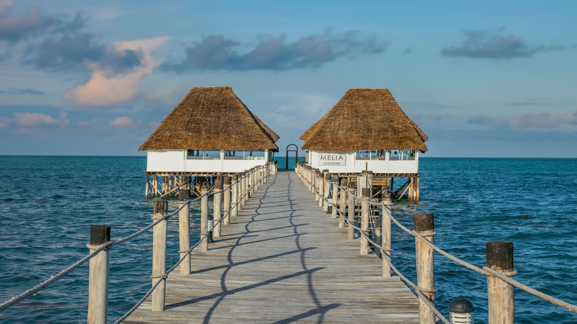 a dock leading to two huts