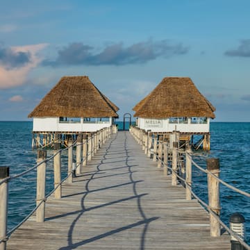 a dock leading to two huts
