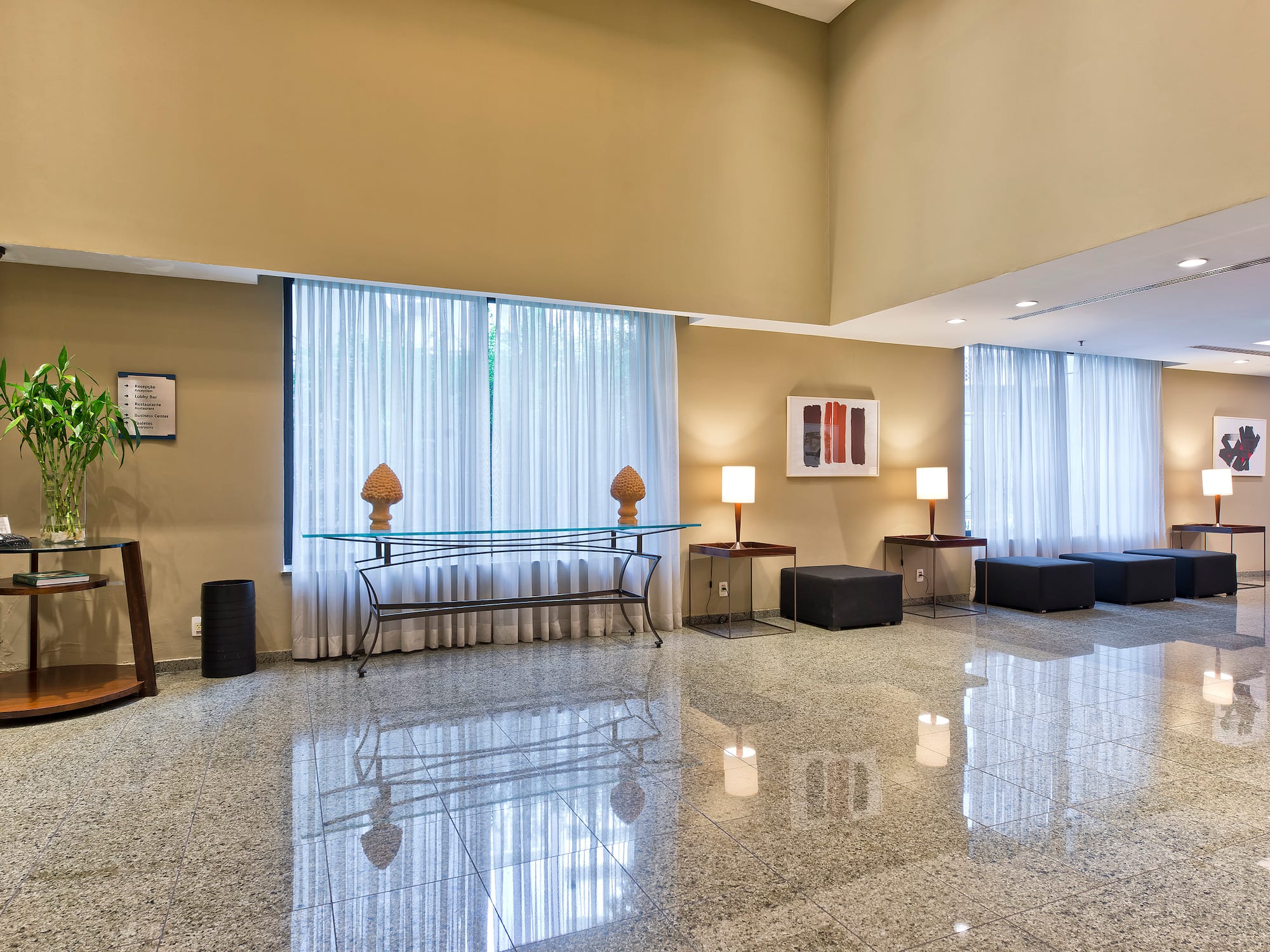 a room with a glass table and chairs