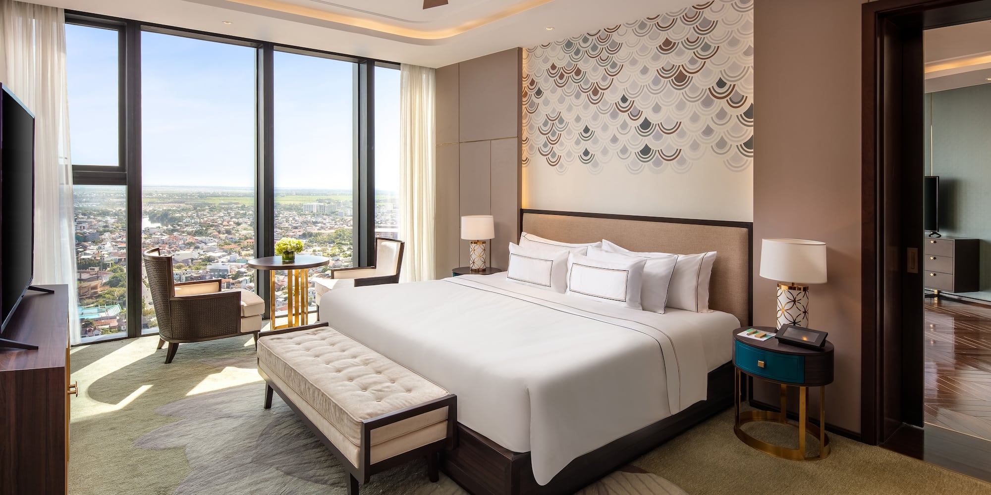 a room with a bed and a table and chairs