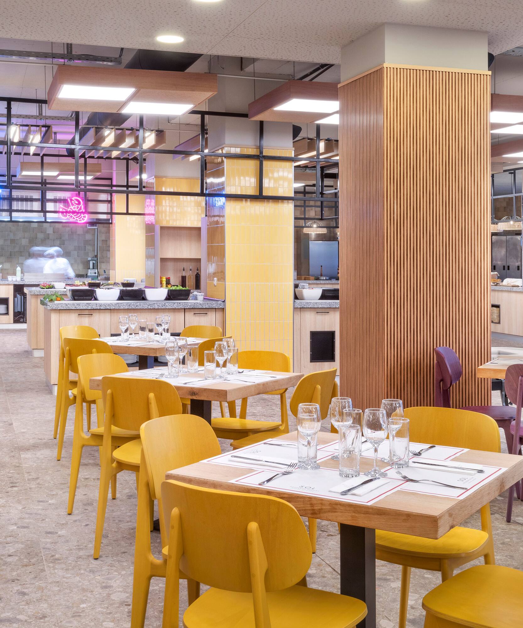 a restaurant with yellow chairs and tables