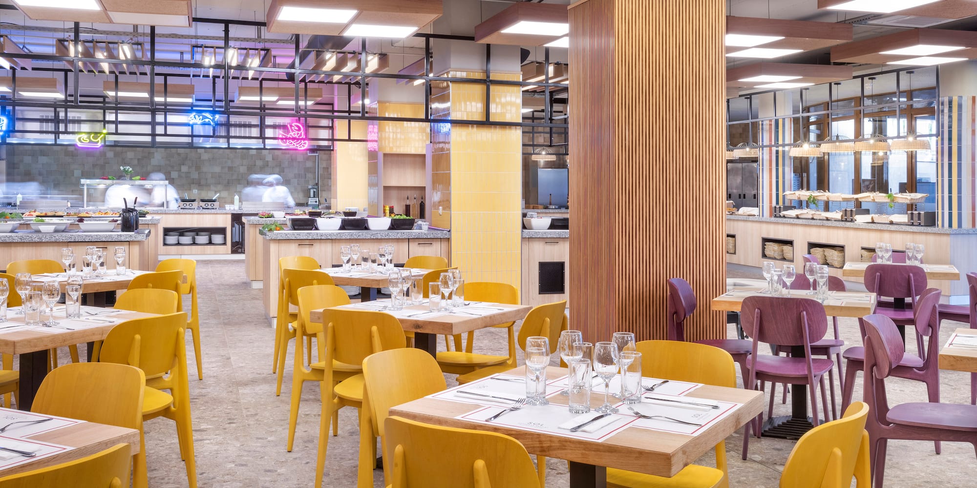 a restaurant with yellow chairs and tables