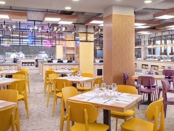 a restaurant with yellow chairs and tables