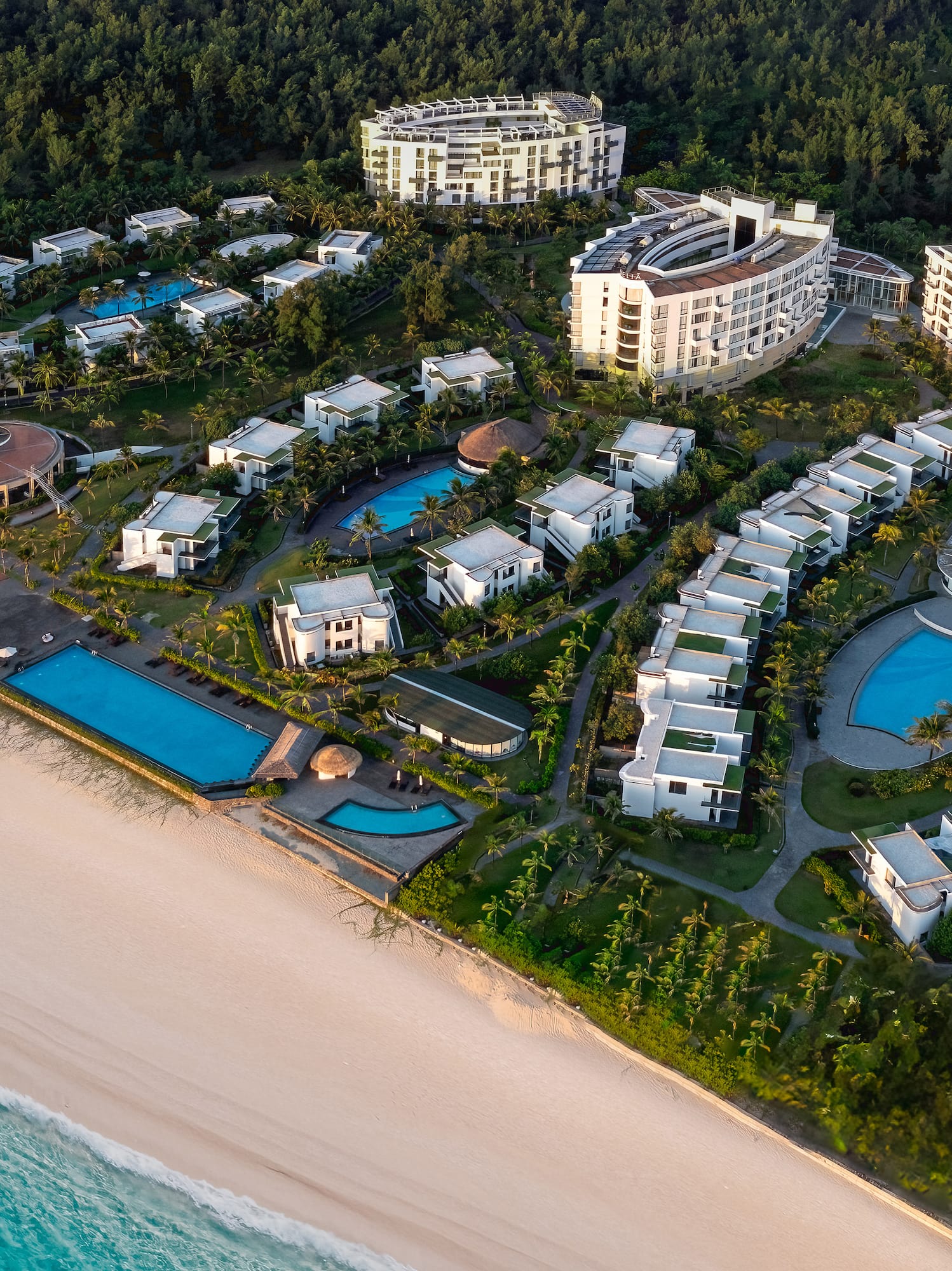 a group of buildings next to a beach