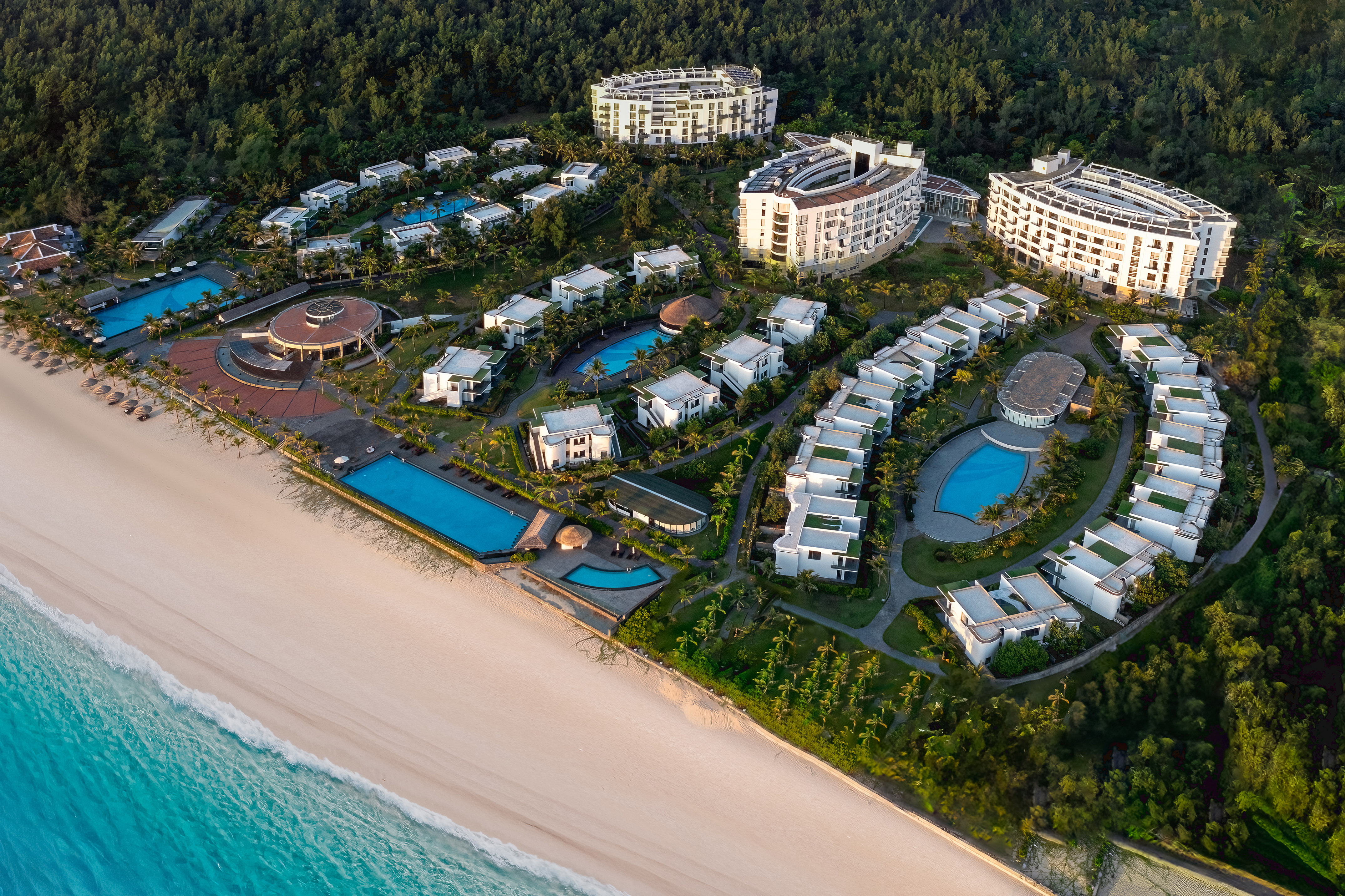 a group of buildings next to a beach