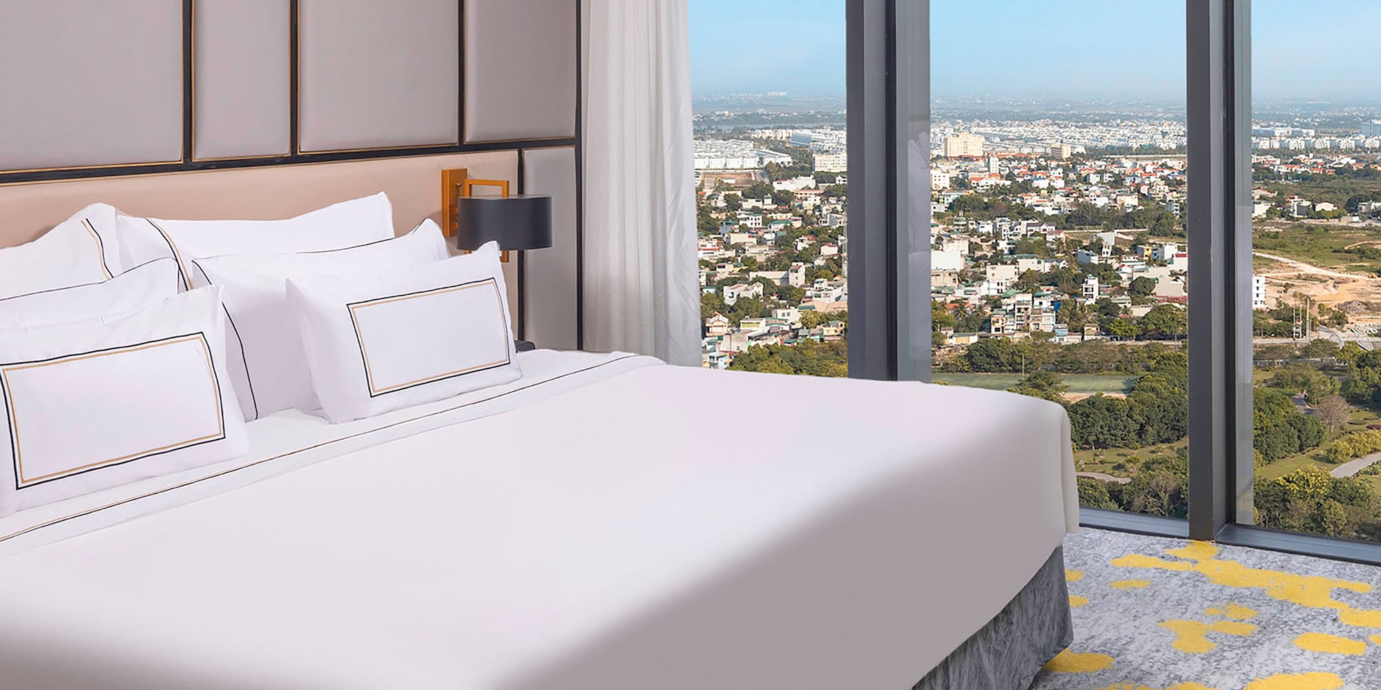 a bed with a view of a city