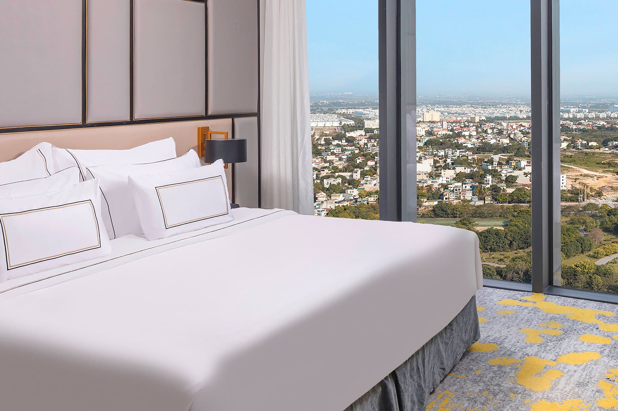 a bed with a view of a city