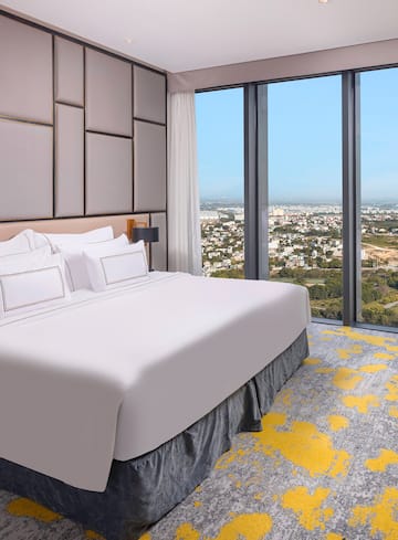 a bed with a view of a city