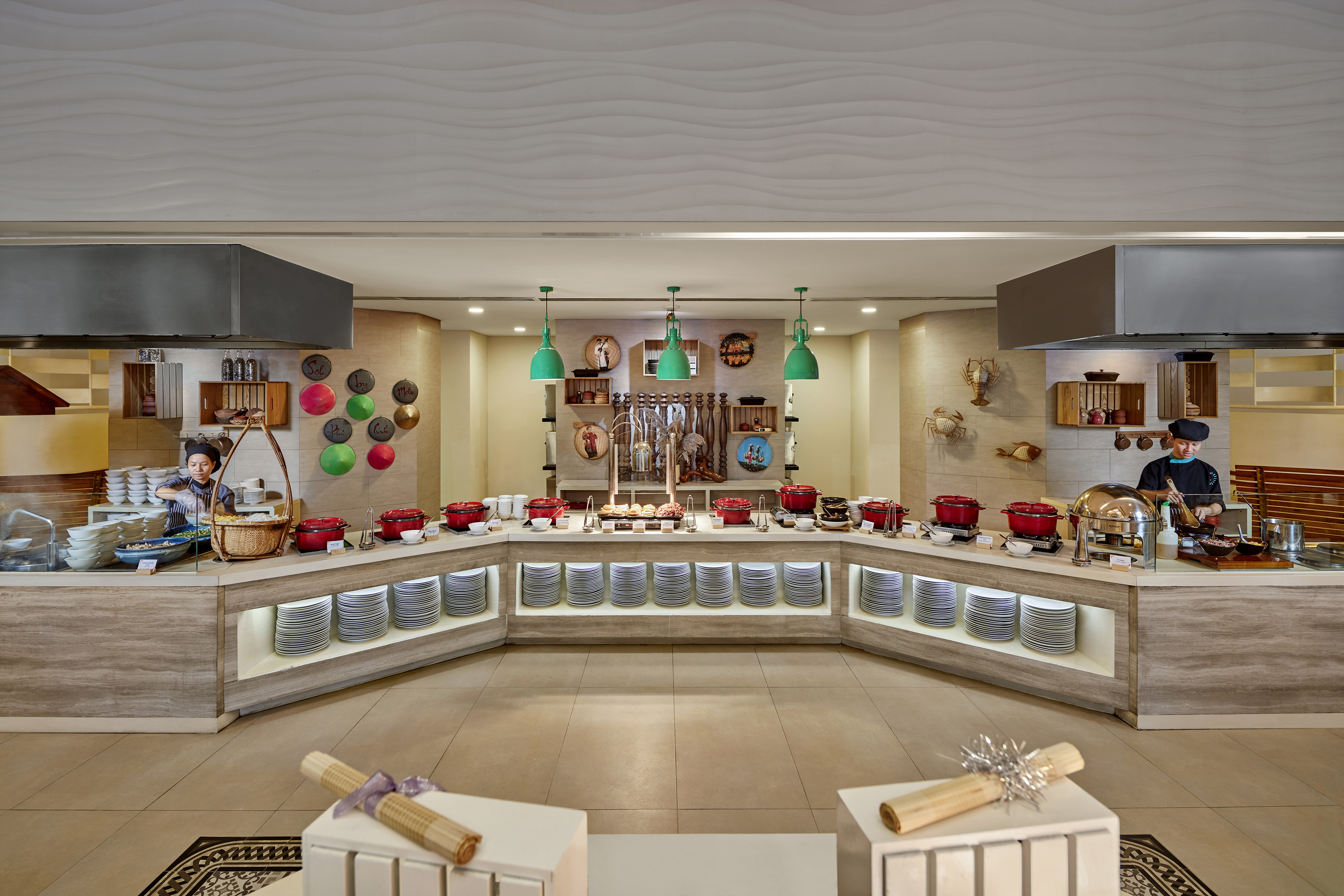 Spacious hotel buffet with live cooking stations, chefs, and hot food selections.