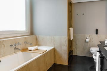 a bathroom with a bathtub and a toilet