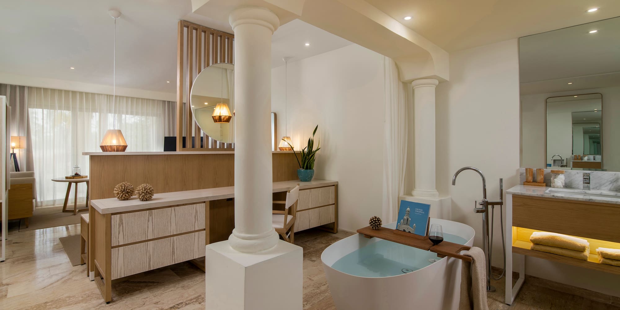 Luxury modern bathroom with freestanding tub, wooden vanity, and spa decor.