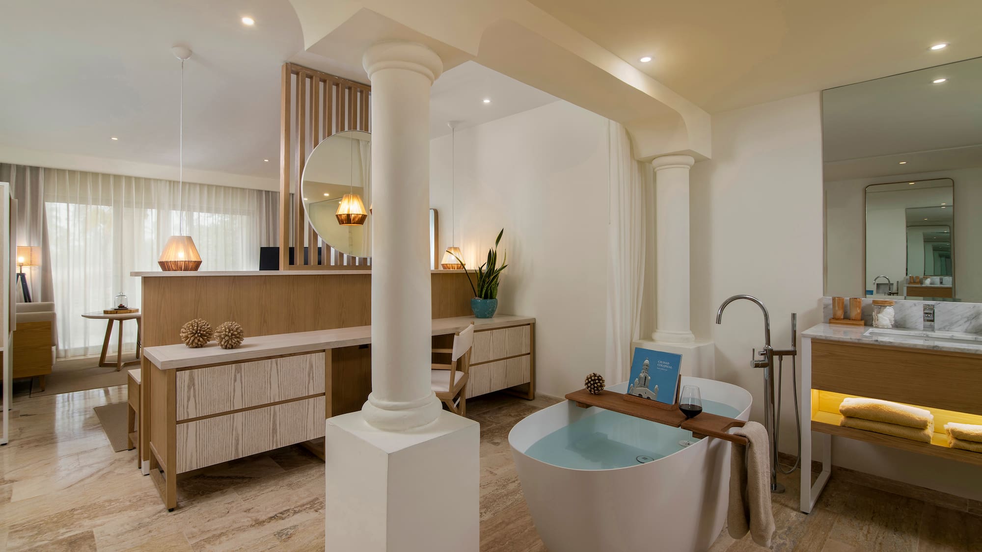 Luxury modern bathroom with freestanding tub, wooden vanity, and spa decor.