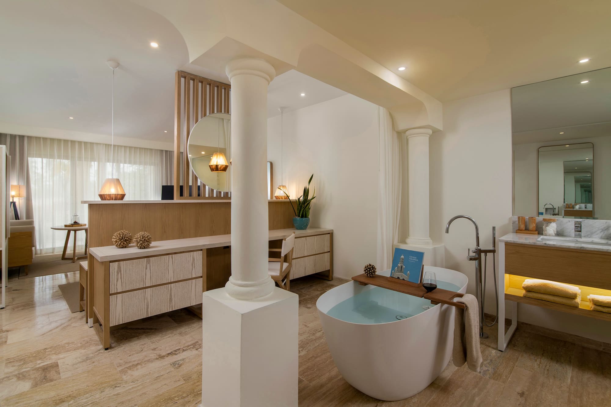 Luxury modern bathroom with freestanding tub, wooden vanity, and spa decor.