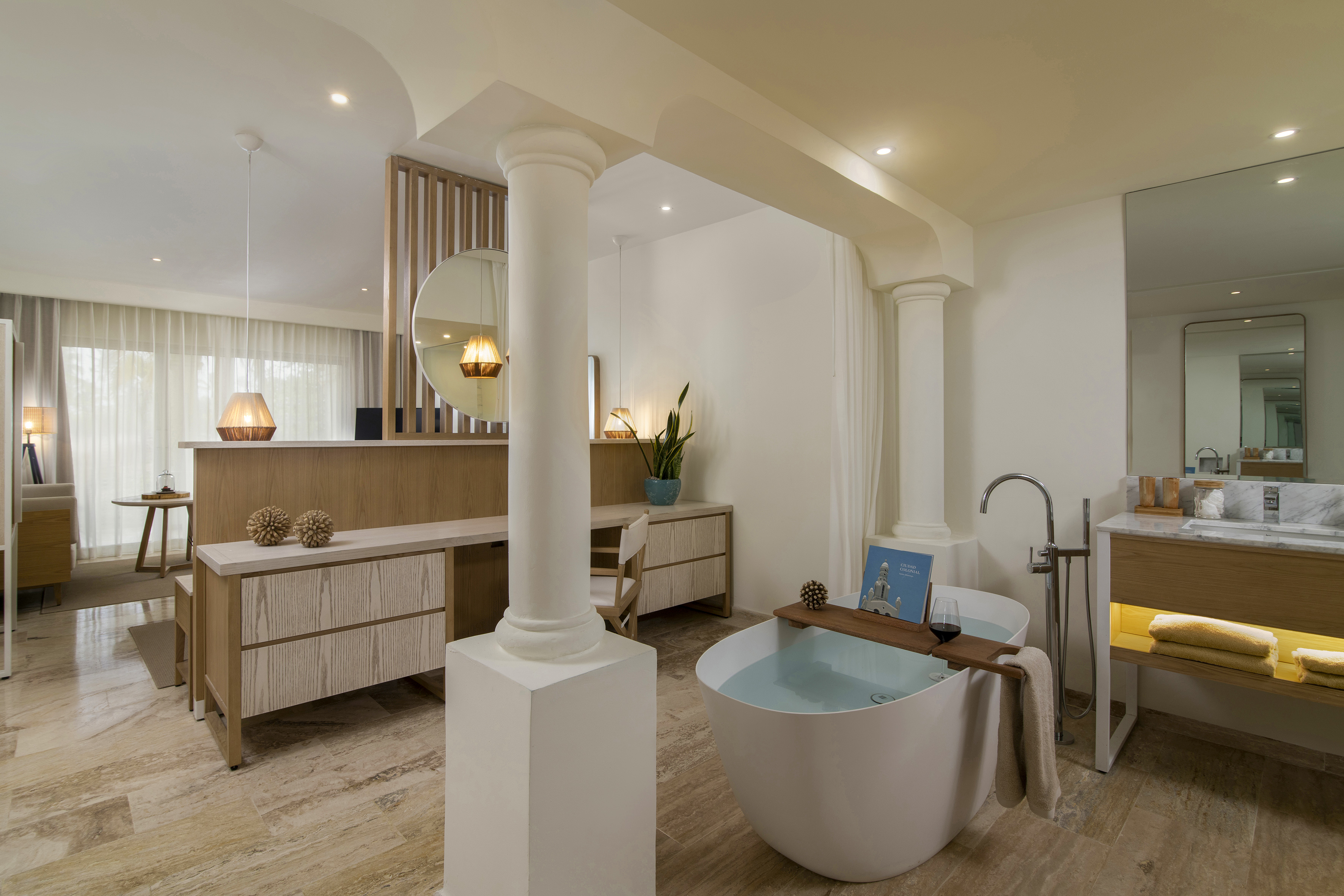 Luxury modern bathroom with freestanding tub, wooden vanity, and spa decor.