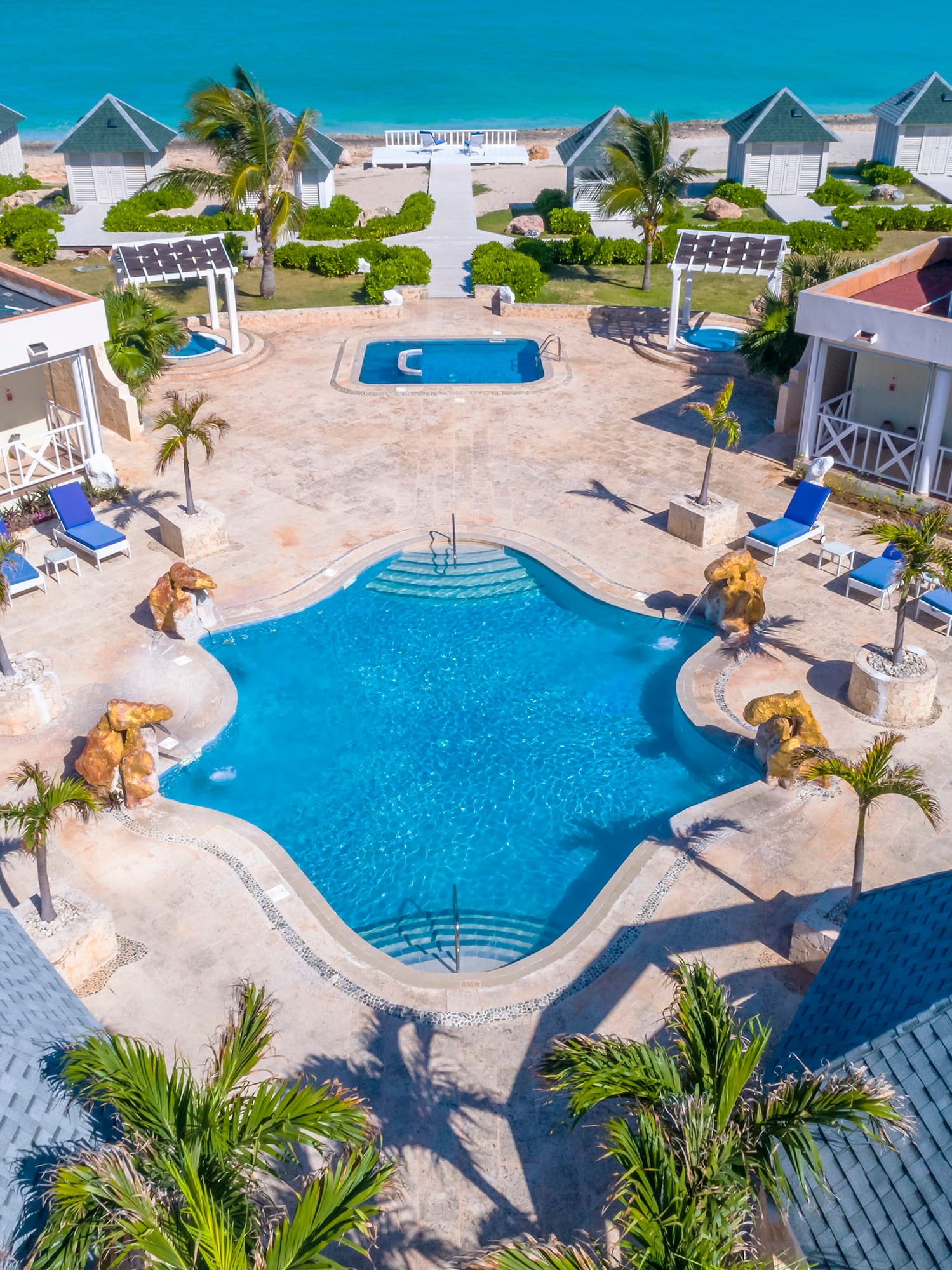 a swimming pool and houses by the ocean