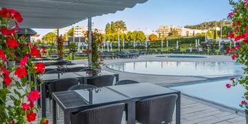 a pool with chairs and tables