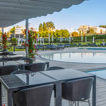 a pool with chairs and tables