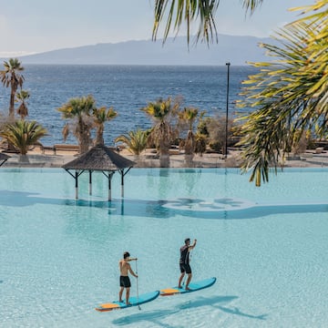 two men on paddle boards in a pool