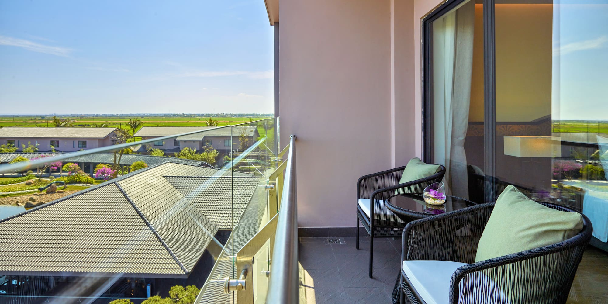 a balcony with chairs and a table