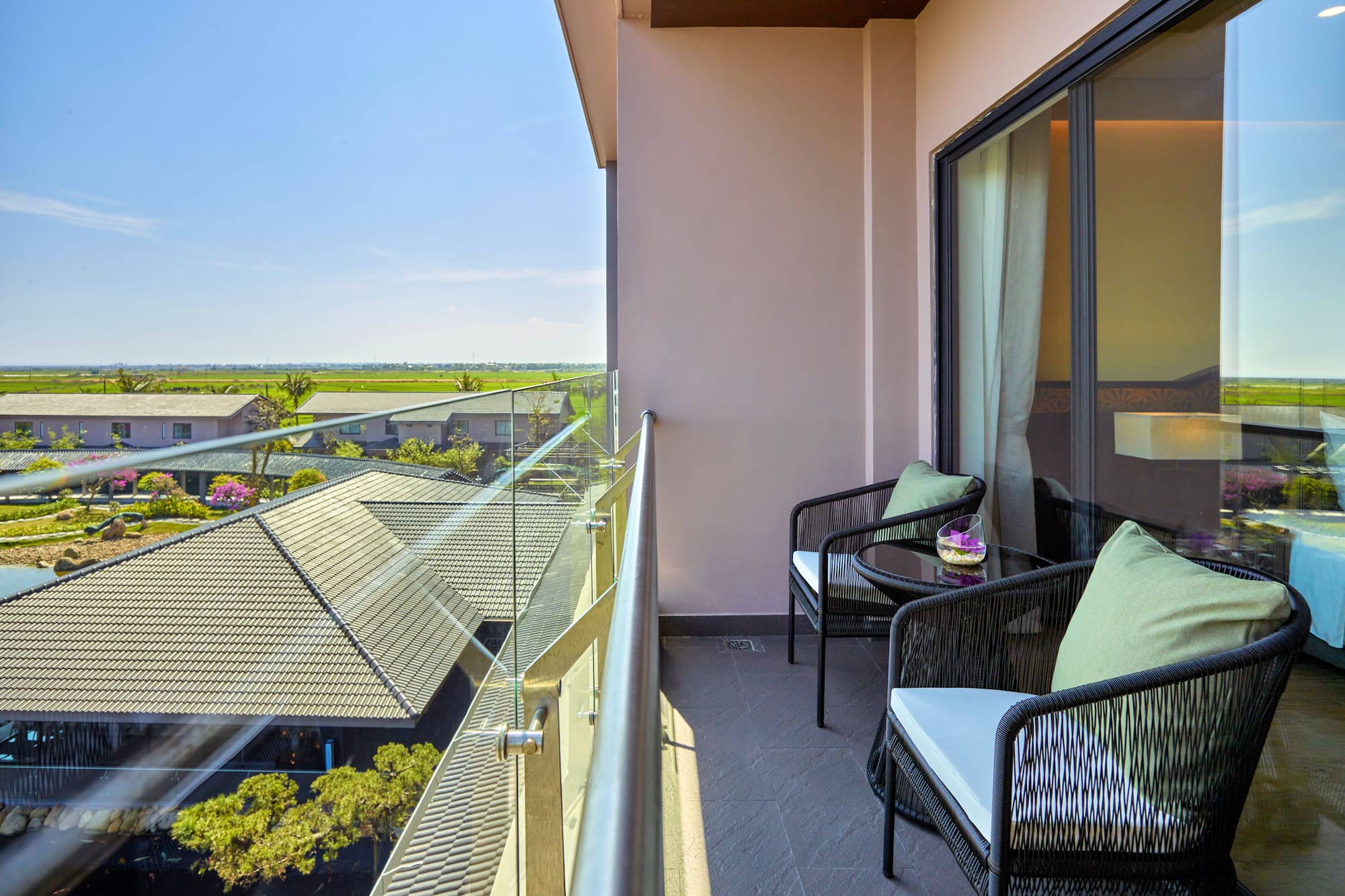 a balcony with chairs and a table