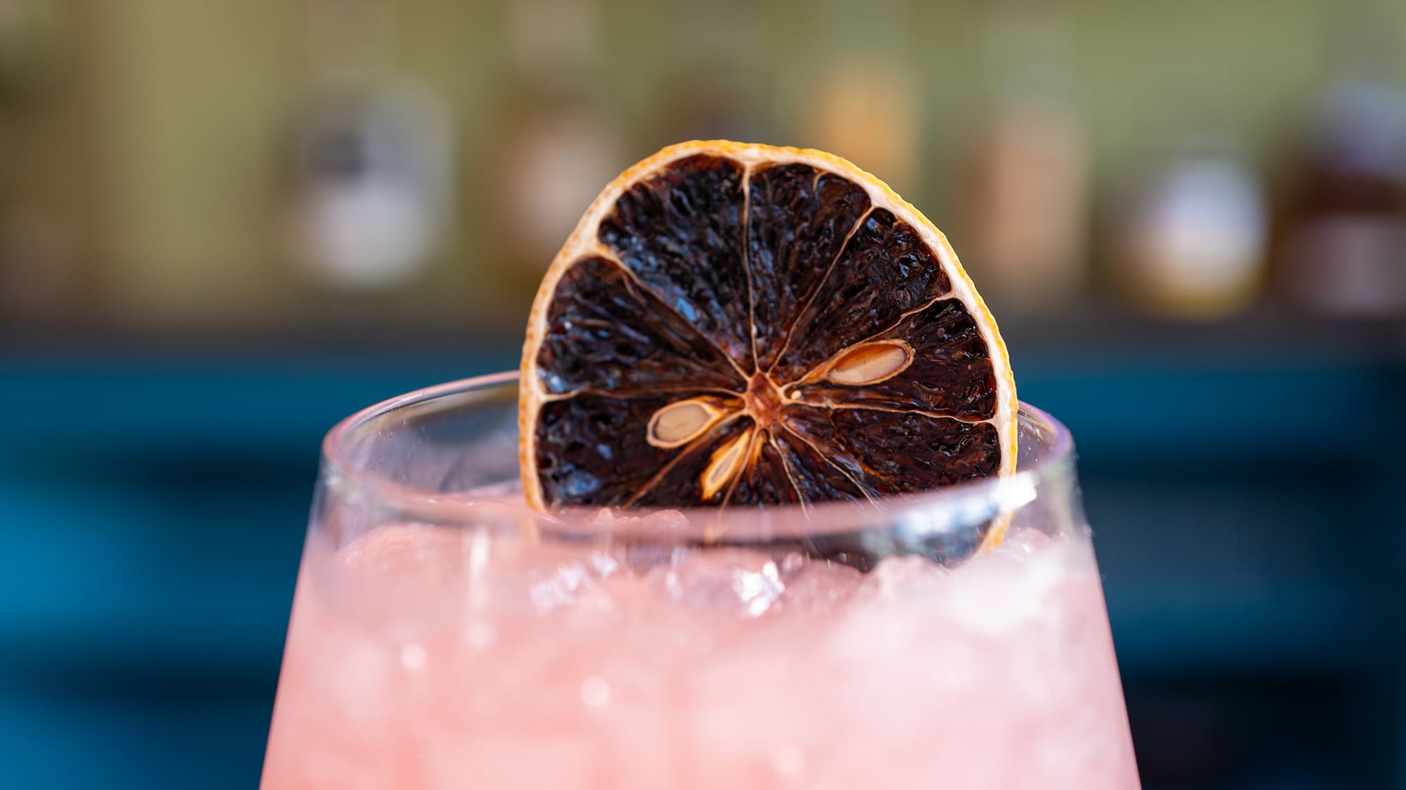 a glass with a slice of orange on top of it