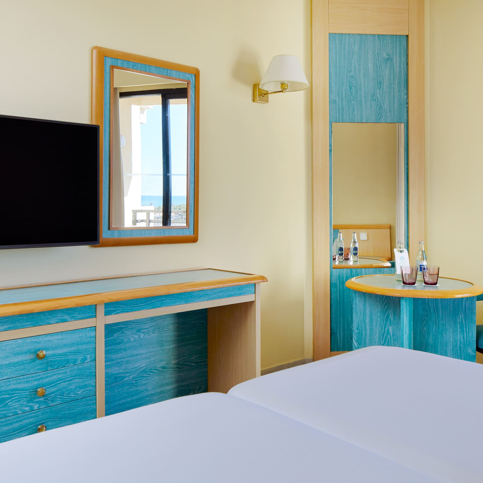 a room with a television and a mirror