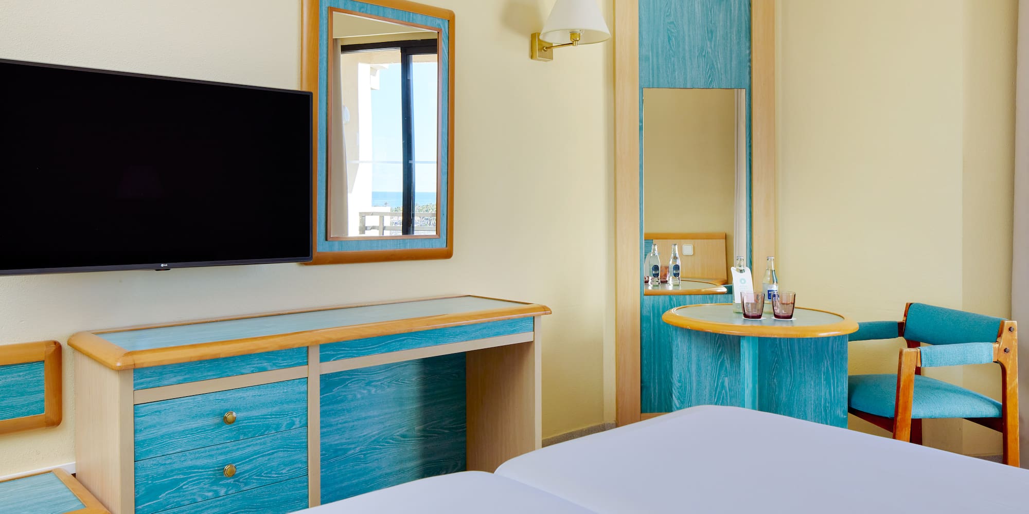 a room with a television and a mirror