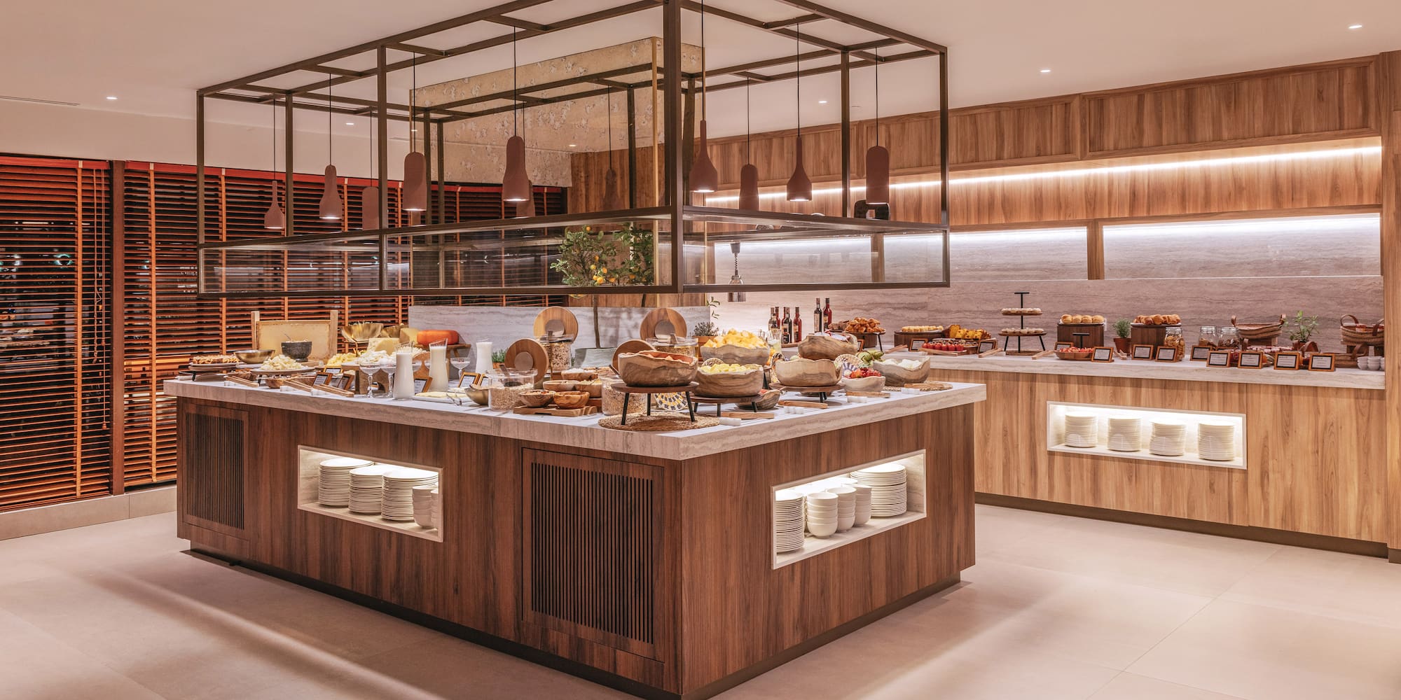 Modern hotel breakfast buffet with diverse food, fruit, and pastries.