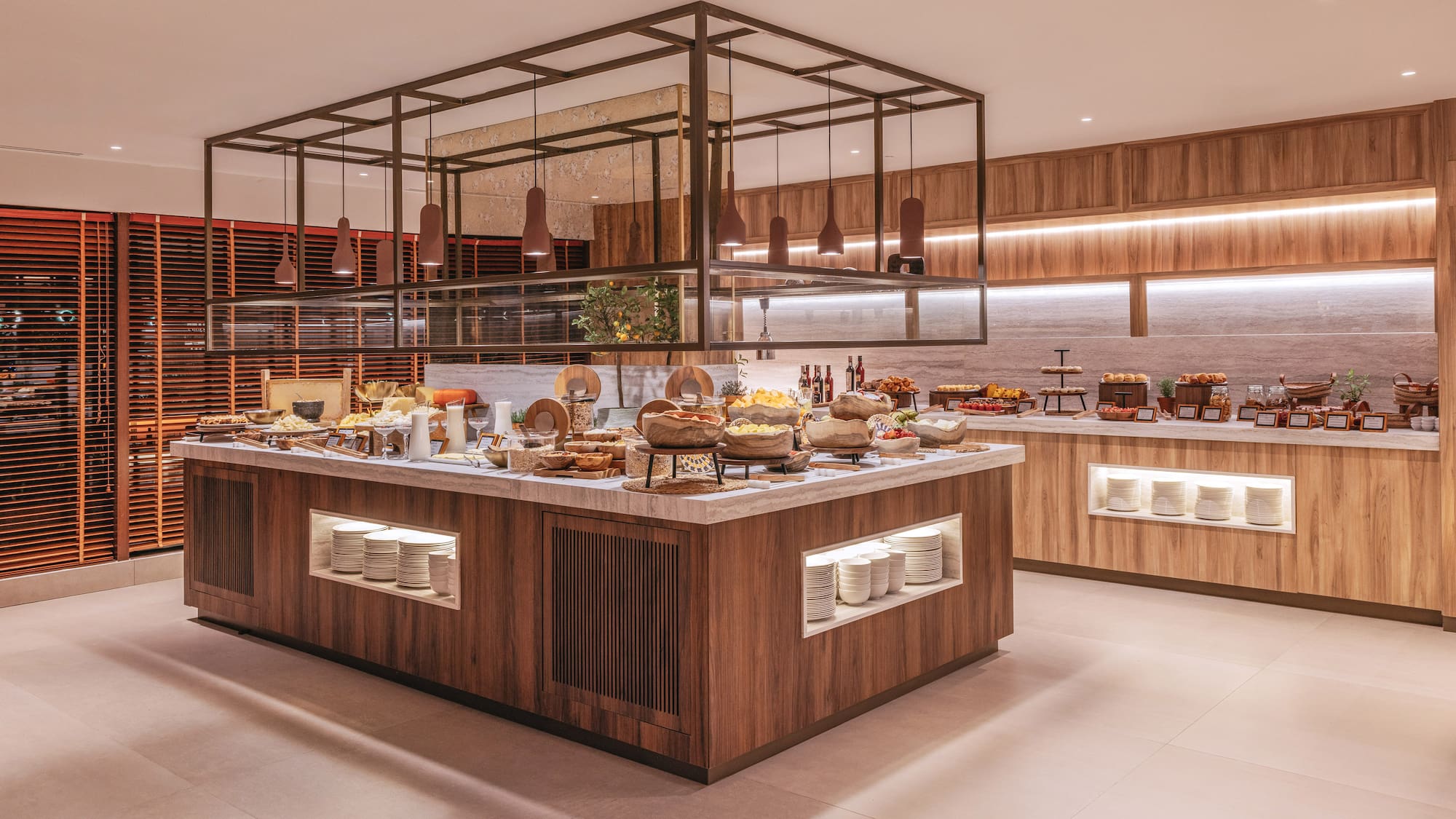 Modern hotel breakfast buffet with diverse food, fruit, and pastries.