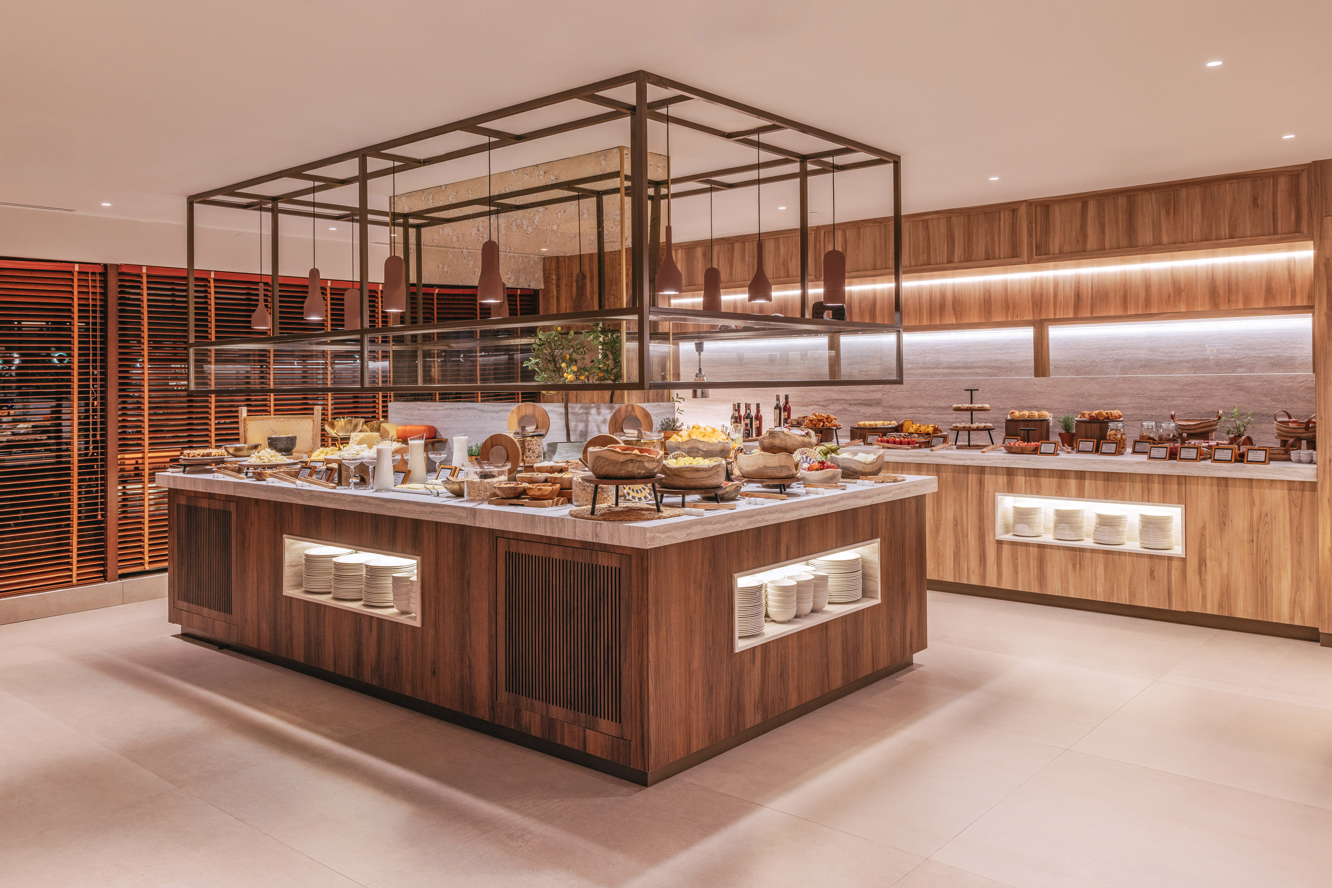 Modern hotel breakfast buffet with diverse food, fruit, and pastries.