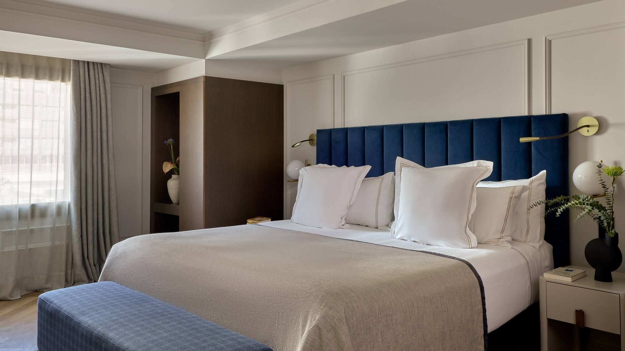 a bed with pillows and a blue headboard in a hotel room
