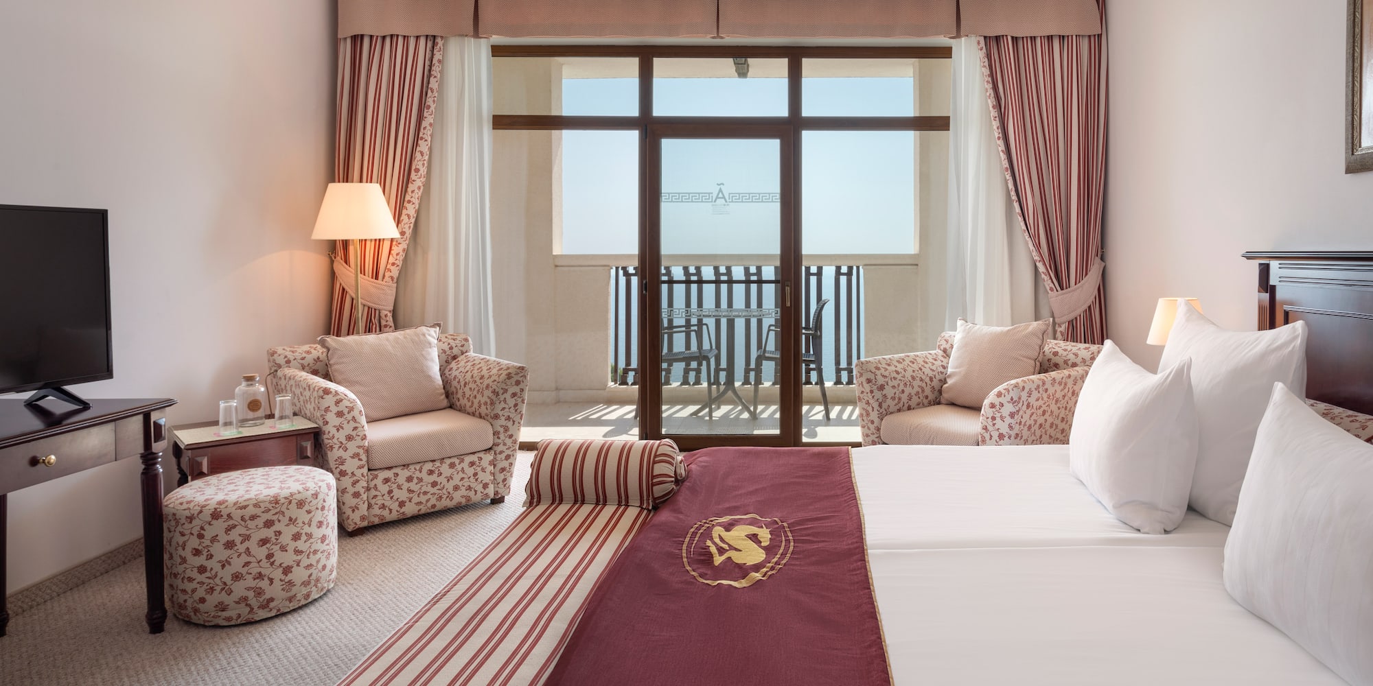 a hotel room with a bed and chairs