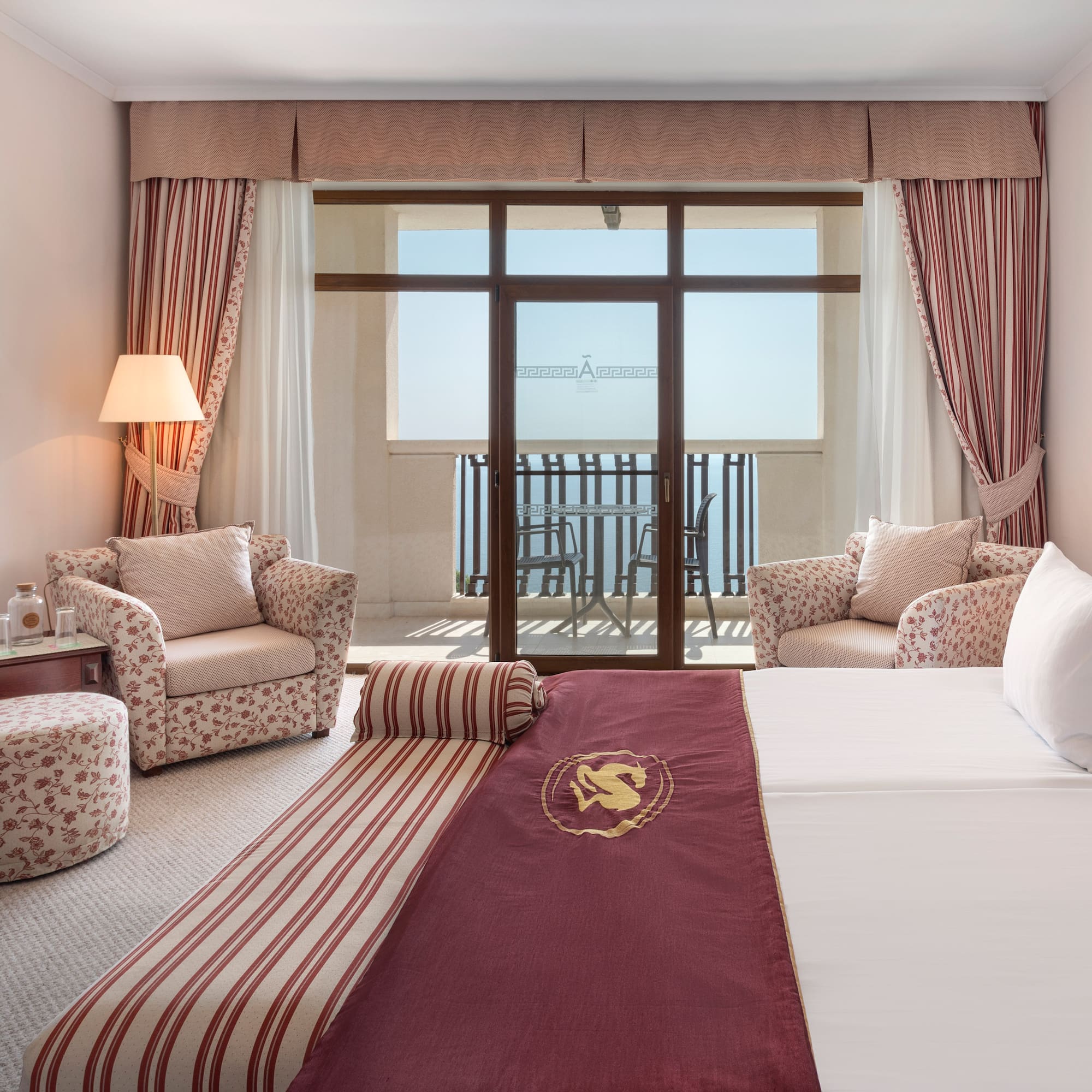 a hotel room with a bed and chairs