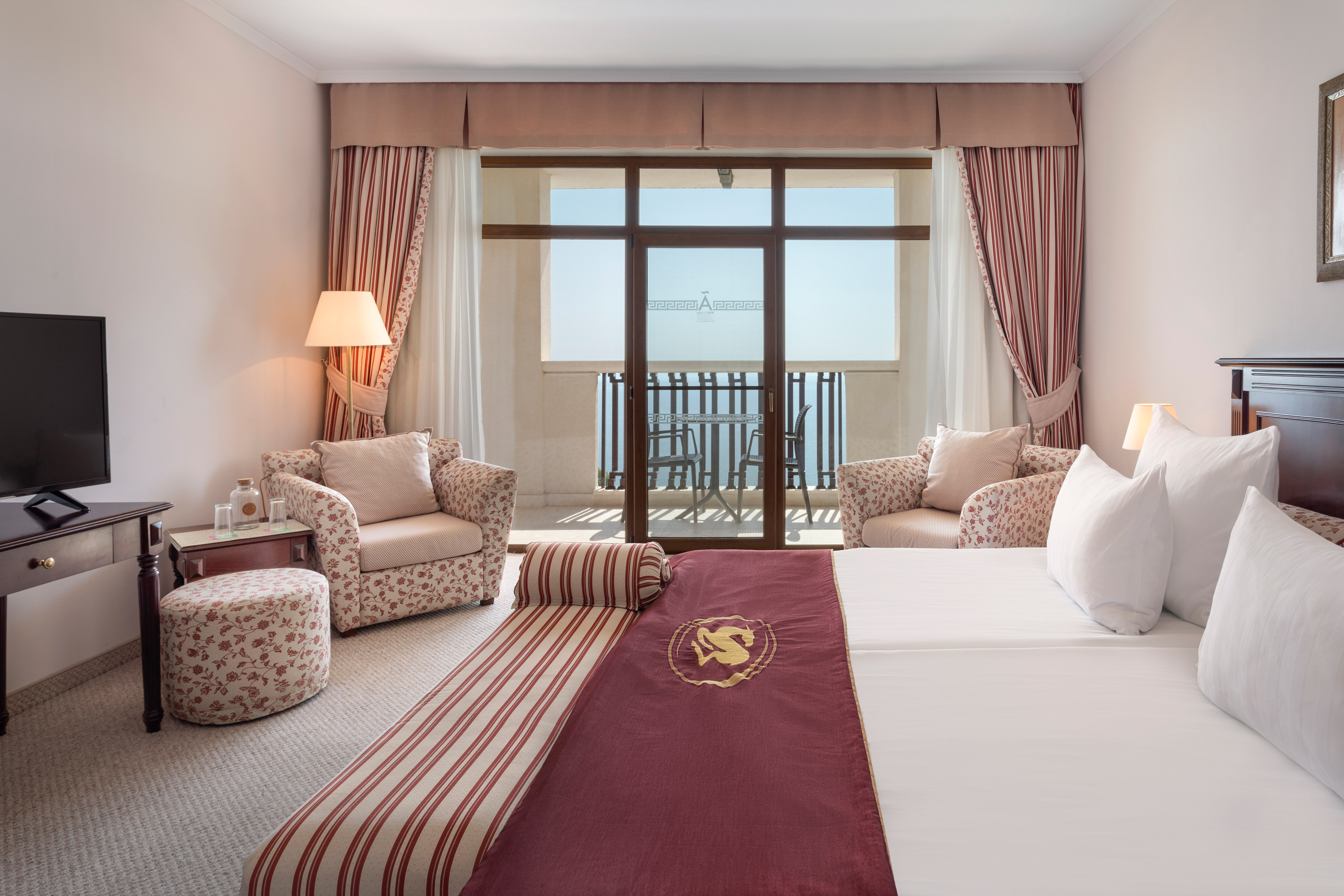 a hotel room with a bed and chairs