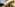 Couple in elaborate Renaissance costumes descending grand villa stairs.