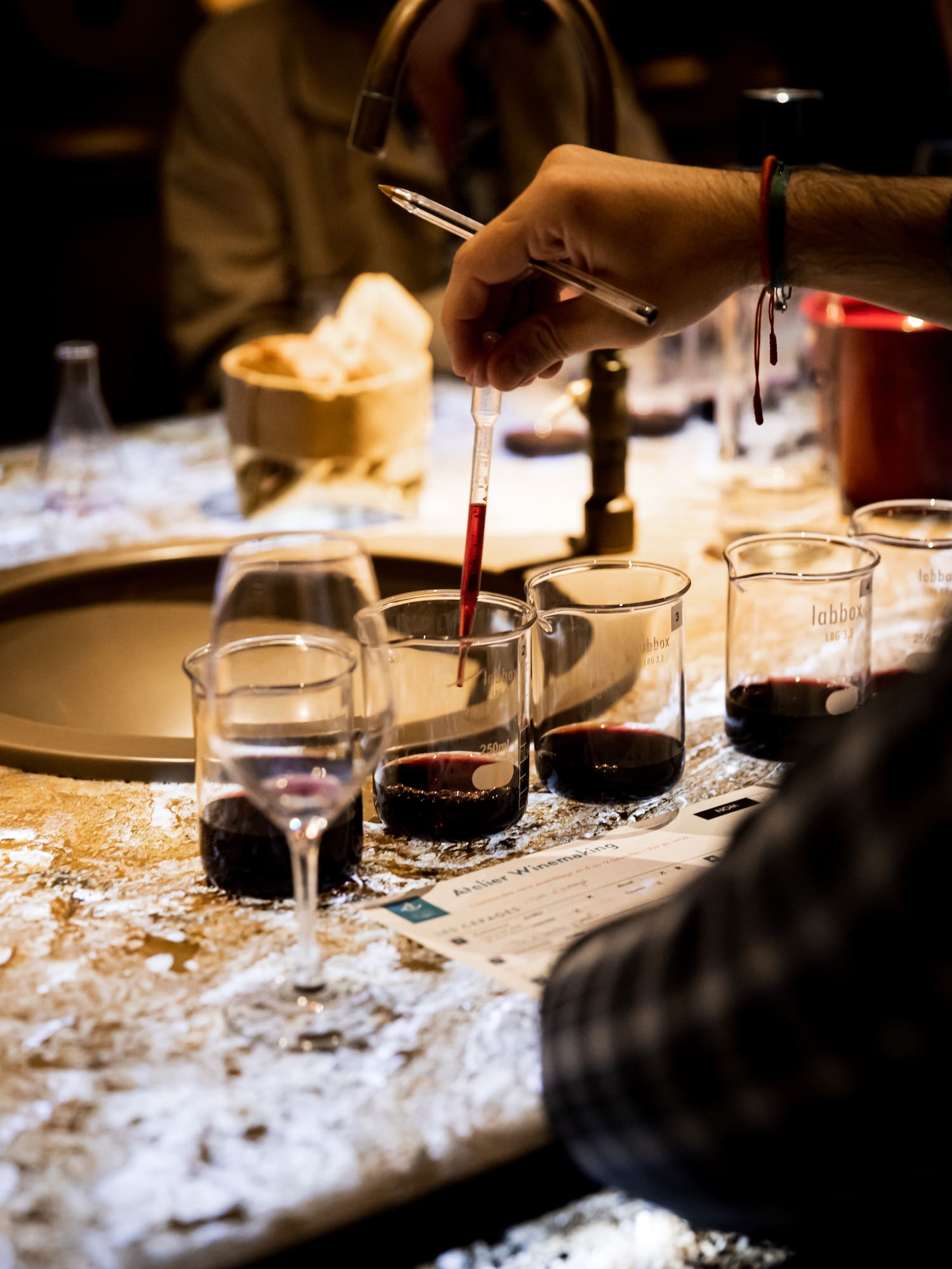 a person pouring liquid into a beaker