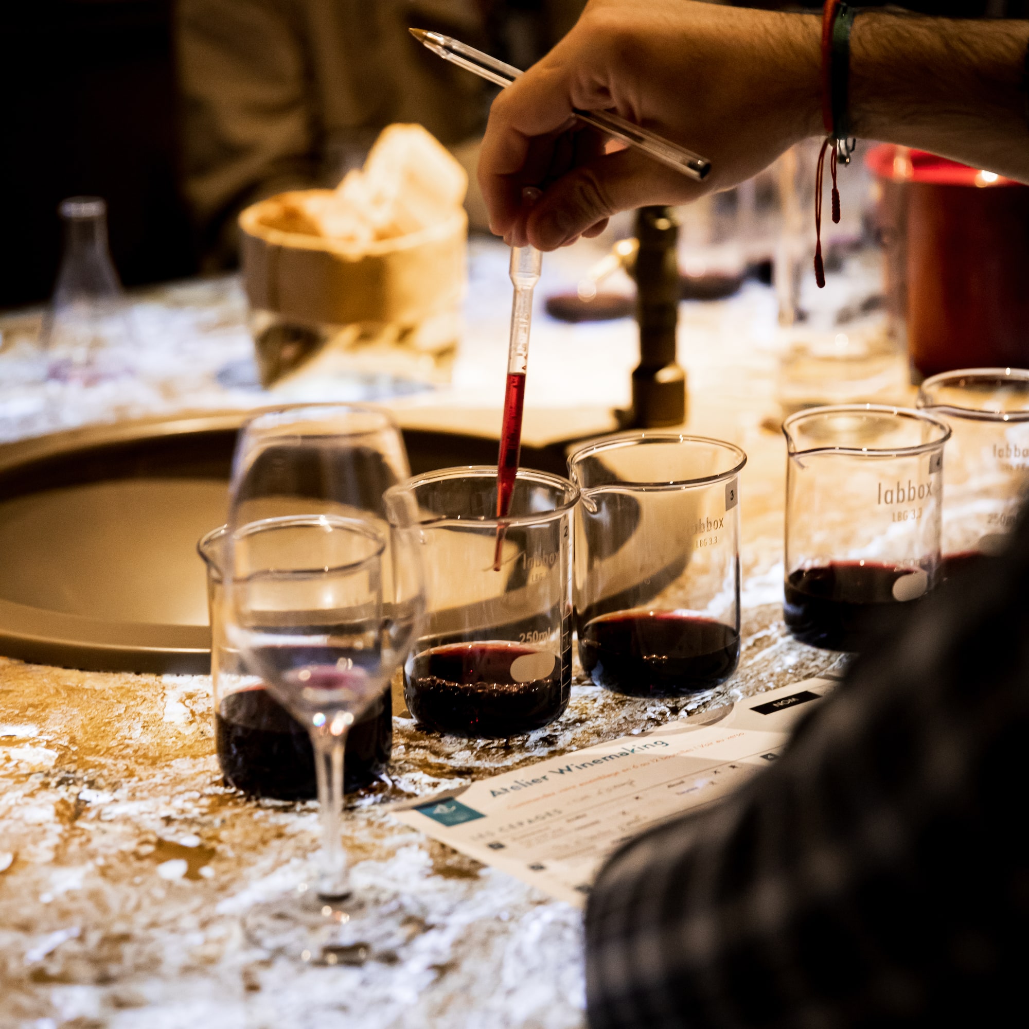 a person pouring liquid into a beaker