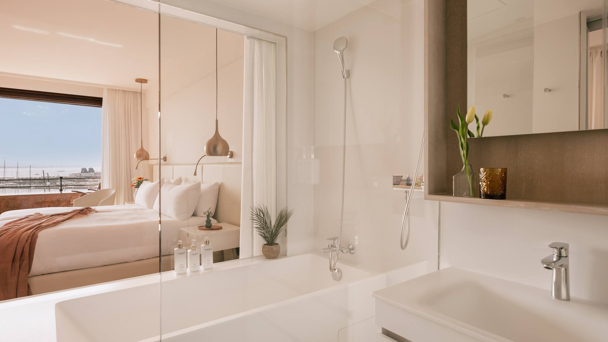 a bathroom with a bathtub and a bed