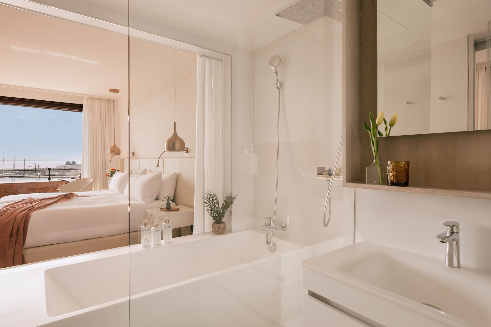 a bathroom with a bathtub and a bed