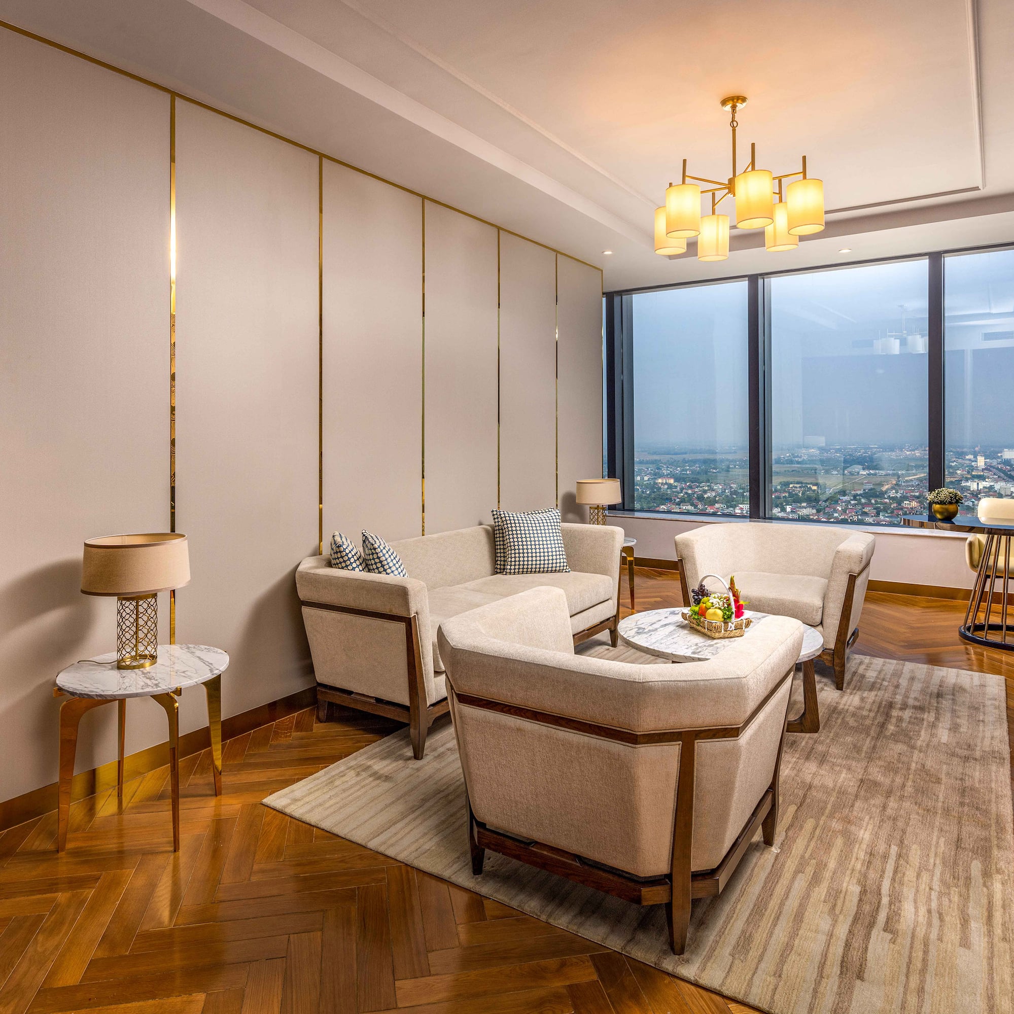 a room with a large window and a couch and chairs