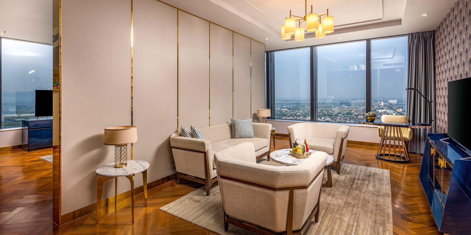 a room with a large window and a couch and chairs