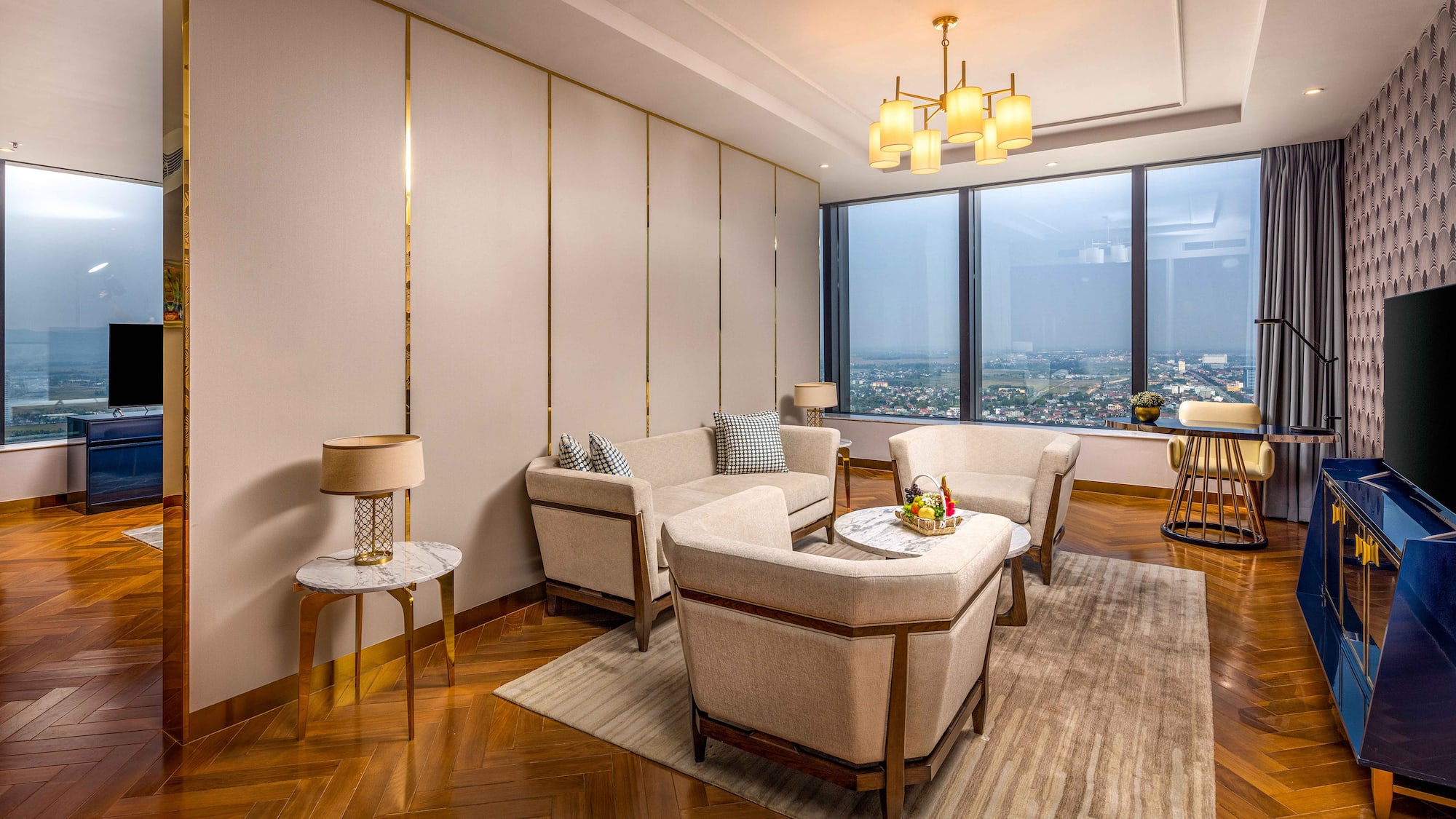 a room with a large window and a couch and chairs