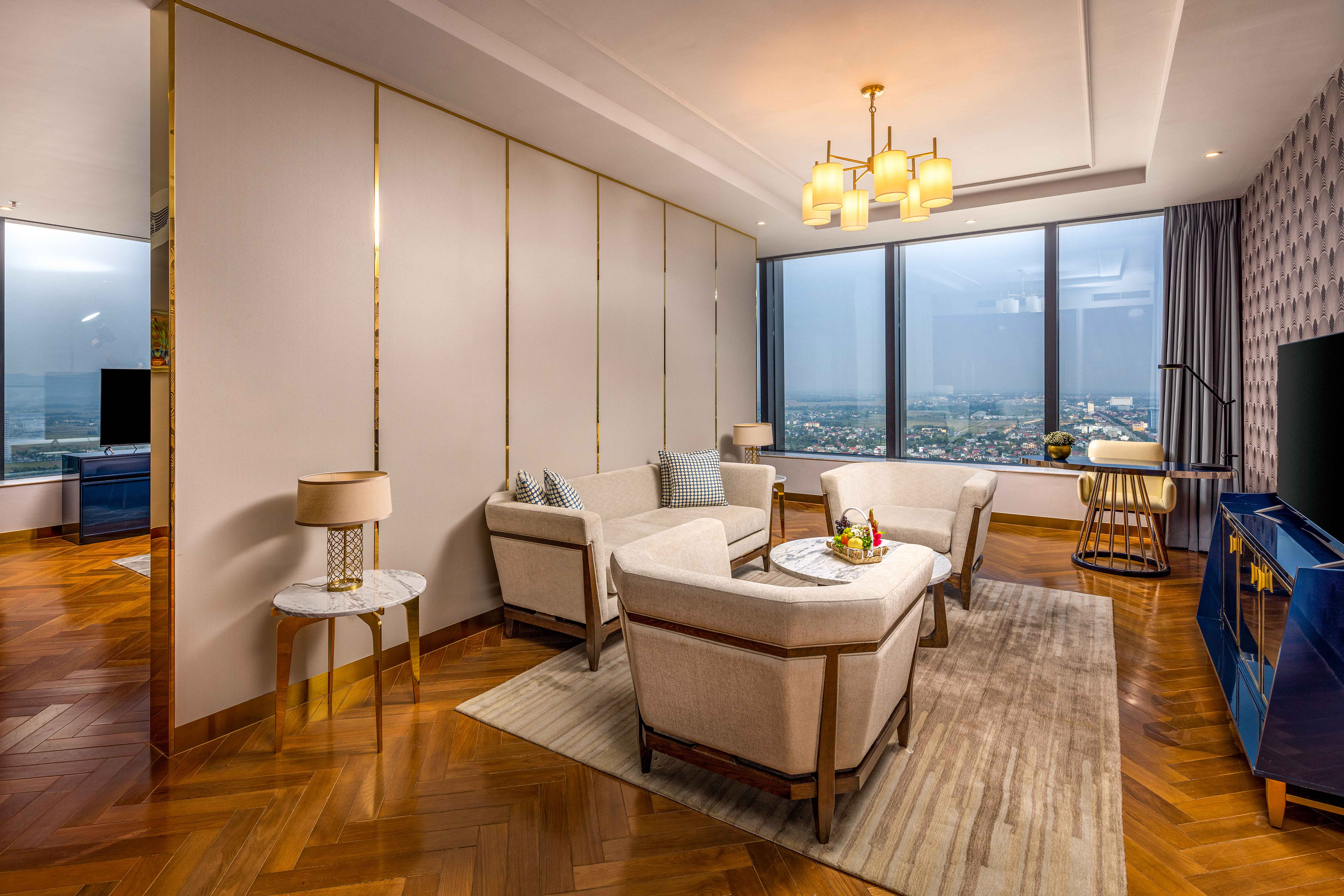 a room with a large window and a couch and chairs