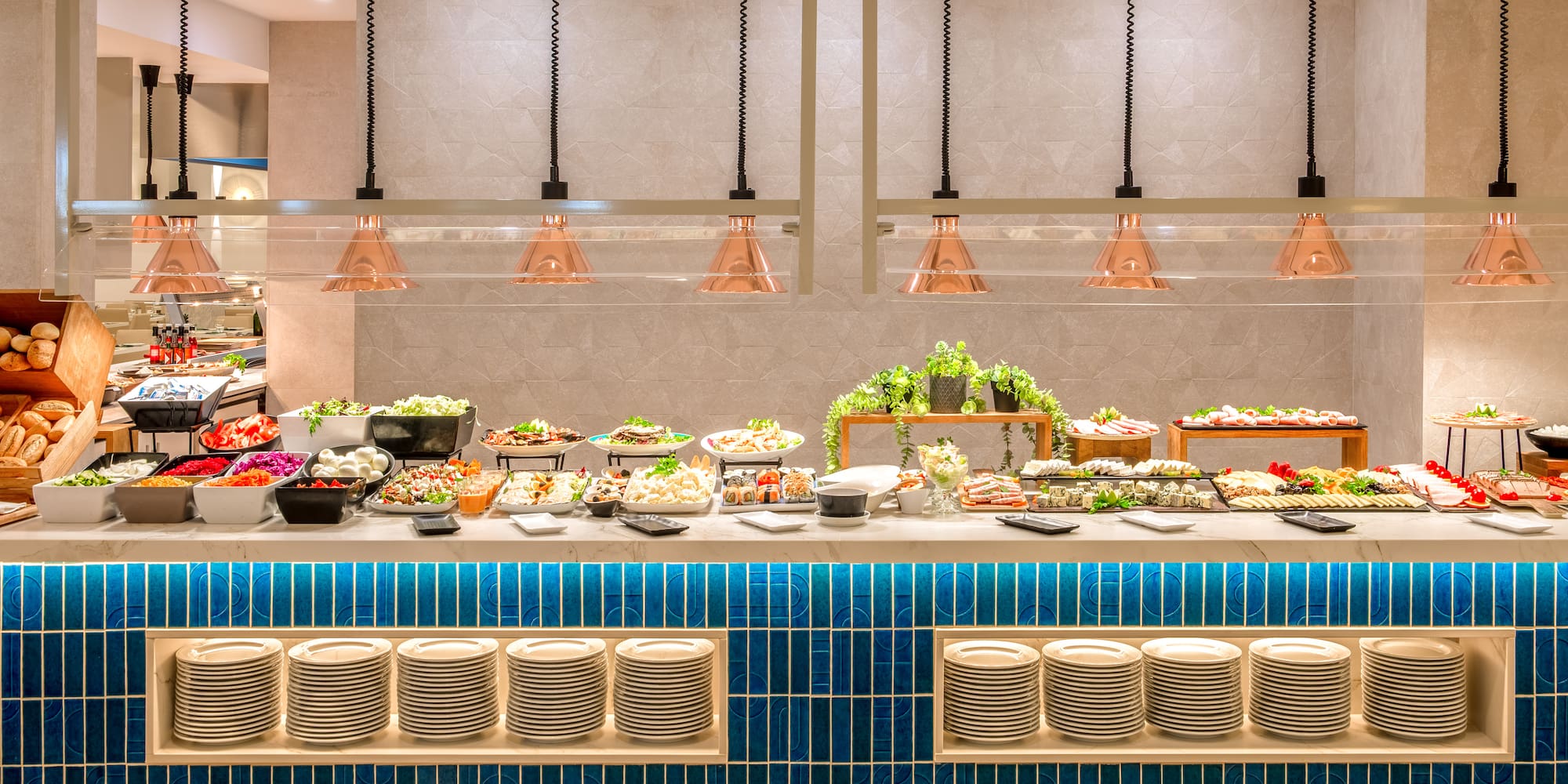 a buffet with plates and food on the counter