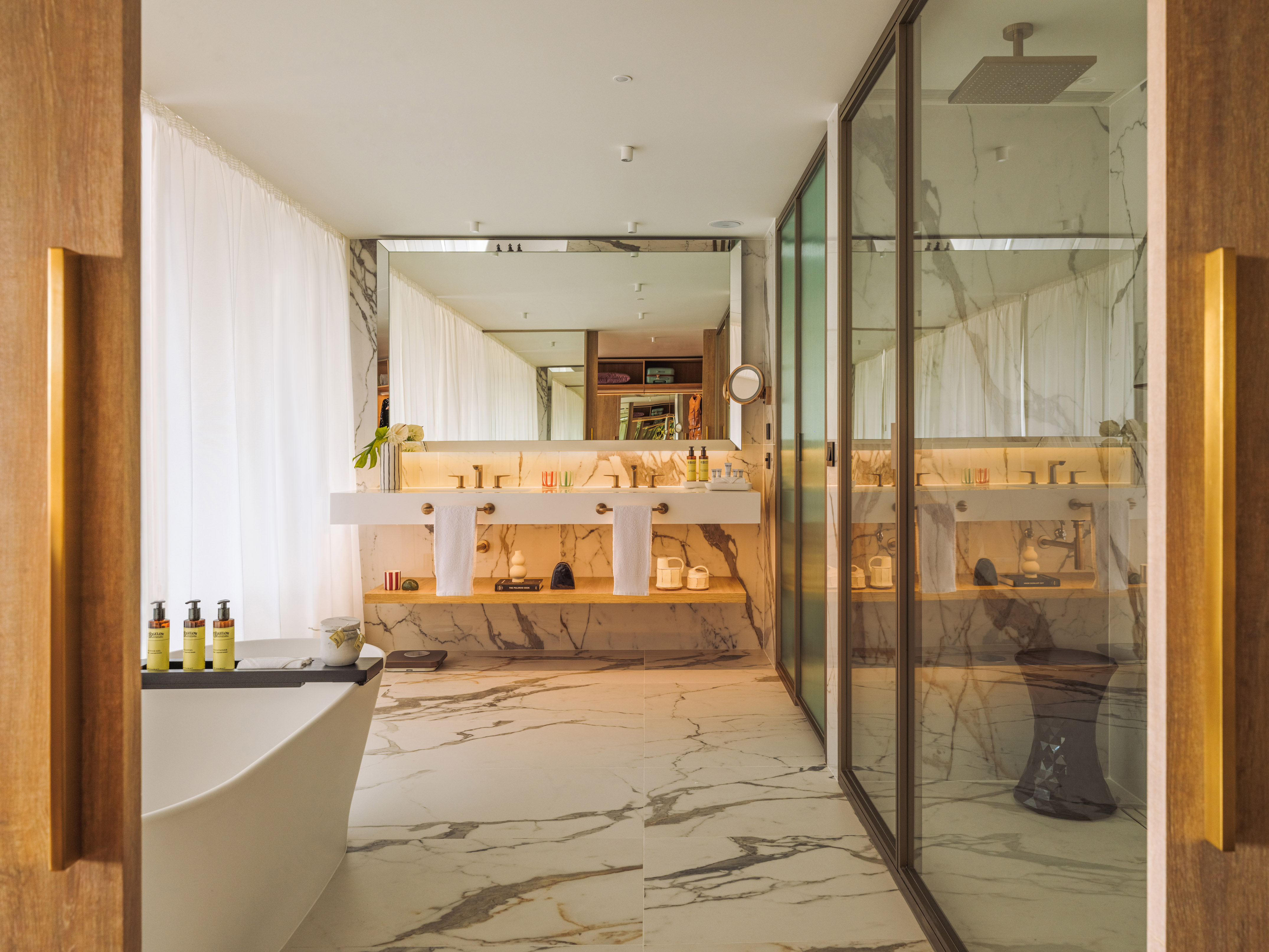 Luxurious marble bathroom, double vanity, freestanding tub, walk-in shower.