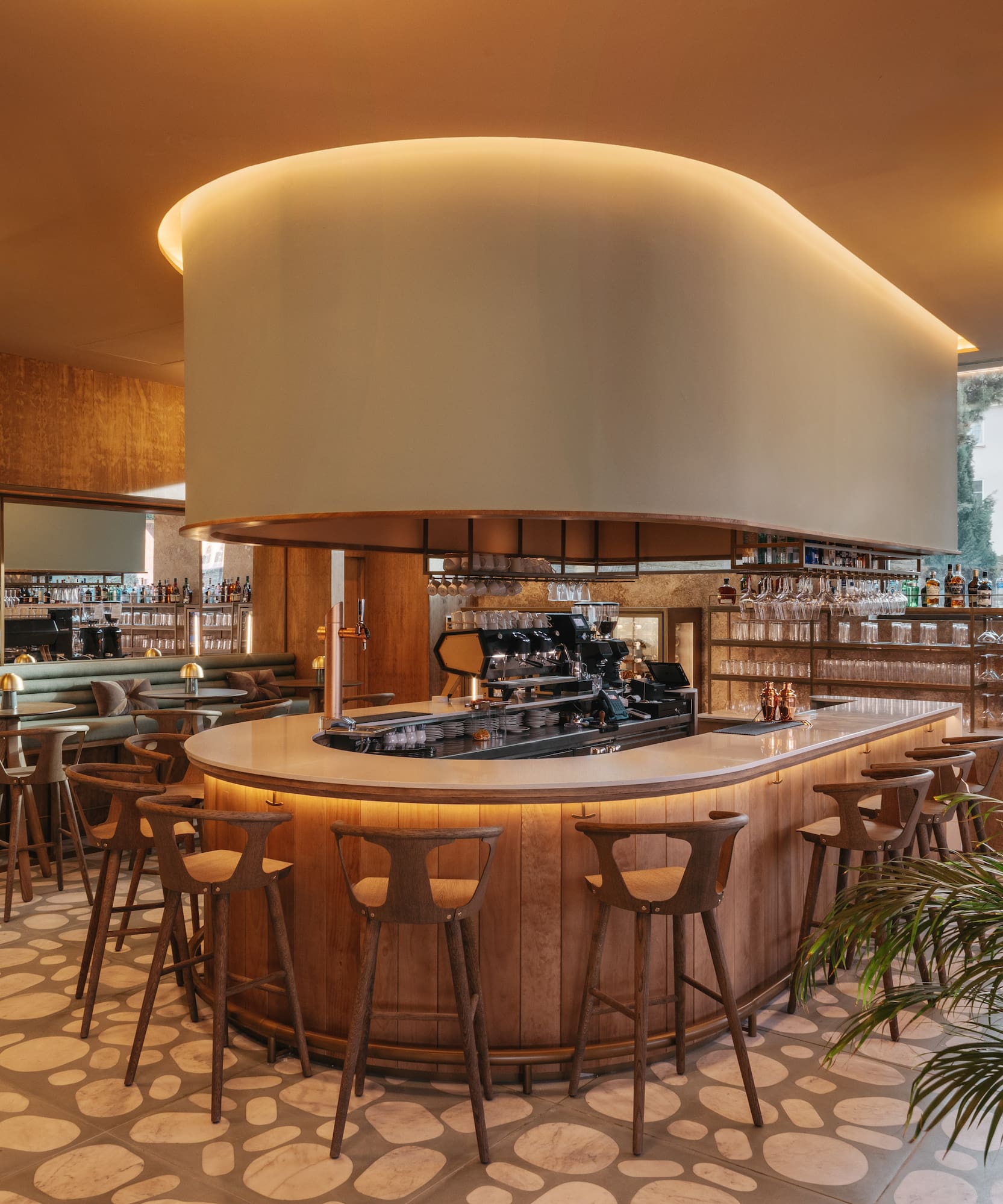 a bar with a large round counter and chairs