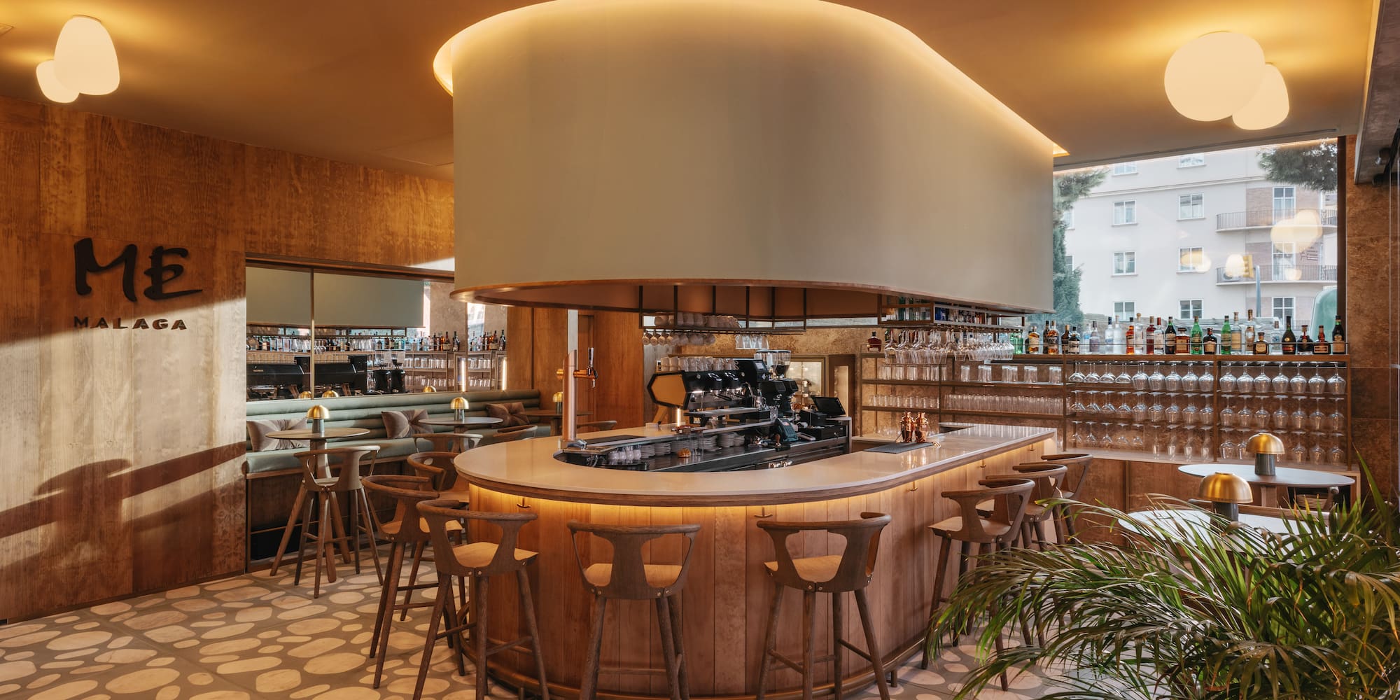 a bar with a large round counter and chairs